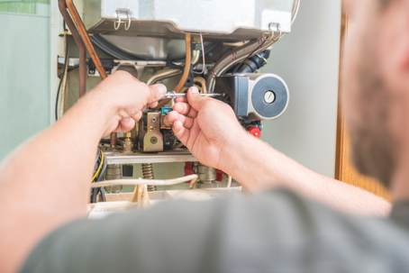 Technician installing a Gas Furnace